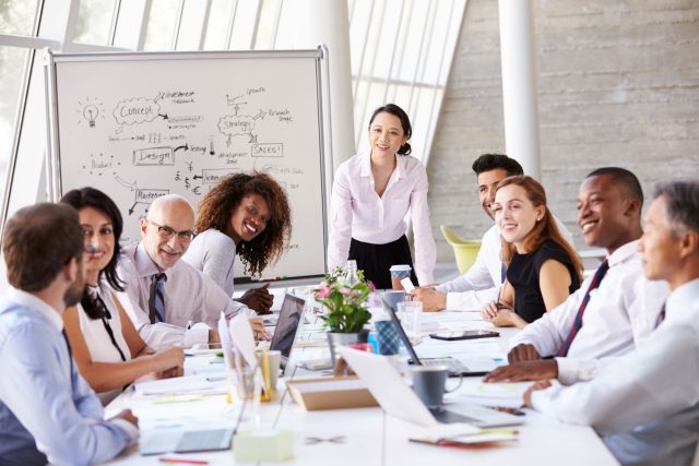 a group of people sitting around a table.